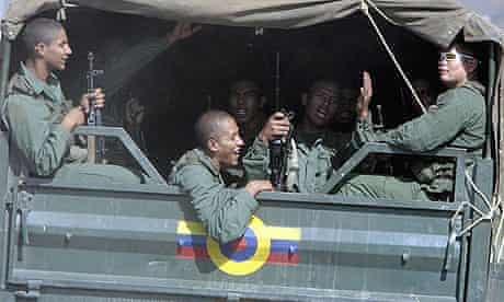 Venezuelan soldiers ride in a military truck towards the Colombian border as their leave their base.