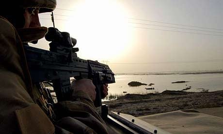 A British soldier patrols the northern suburbs of the southern Iraqi city of Basra