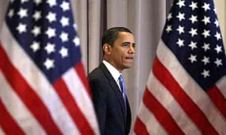 Democratic presidential hopeful Barack Obama walks between two American flags at a news conference in Chicago