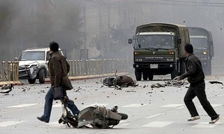 Tibetans throw stones at Chinese army vehicles in Lhasa as violent protests against Chinese rule break out