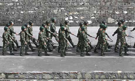 Chinese riot police march through the city of Kangding, Sichuan Province.