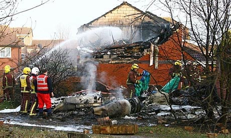 Fire crews attend the site of the aircraft crash in Farnborough, Kent