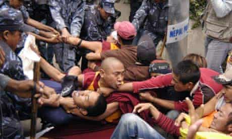 Nepalese police officers detain Tibetan exile protesters demonstrating against the alleged oppression by Chinese authorities