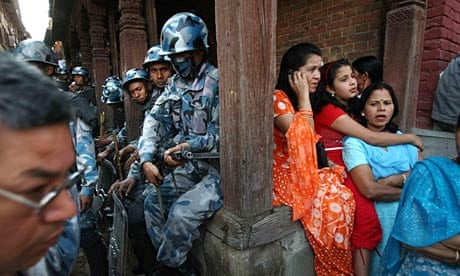 Nepalese women next to policemen.