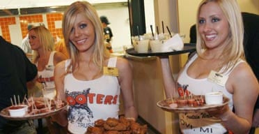 Waitresses serve food and beverages at the opening celebration of the first Israeli branch of Hooters restaurants in Netanya, near Tel Aviv