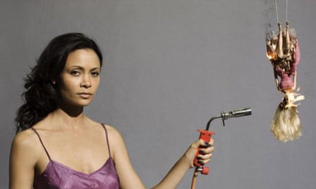 Thandie Newton using a blow torch on a Barbie doll during a protest against the war in Darfur
