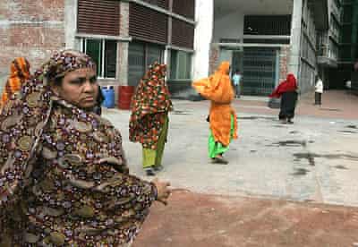 Garment workers enter their factory, south of Dakha, before going on strike