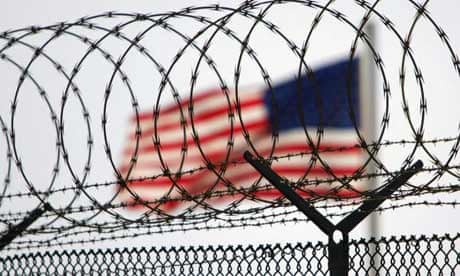 A US flag waves within the razor wire-lined compound of Camp Delta prison at Guantánamo Bay in 2006
