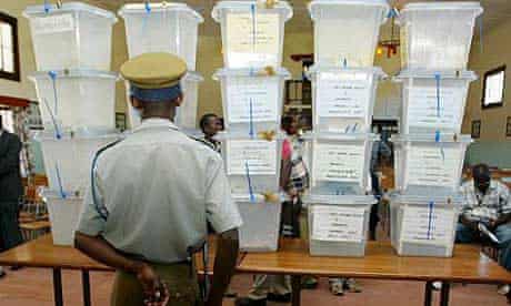 A police officer stands in front of stacked ballot boxes in Zimbabwe