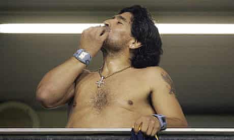 Diego Maradona smokes a cigar at the end of the Copa Libertadores match between Boca Juniors and Venezuela's Union Atletico Maracaibo at La Bombonera stadium, in Buenos Aires.