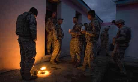 US soldiers from Charlie Company, 173rd Brigade (Airborne) keep warm at a coalition-built school in Rabat, Afghanistan