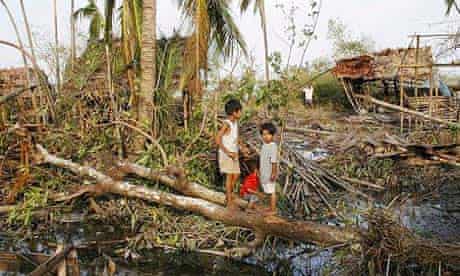Children standing amid the debris of their village, which was destroyed by the cyclone, near the township of Kunyangon, Burma