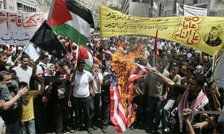 Palestinians set a US flag on fire during a Nakba rally in the West Bank city of Nablus