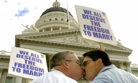 Jim Alley, left, and Warren Hickison kiss in front of the State Capitol building, Sacramento, during a rally in support of gay marriage rights