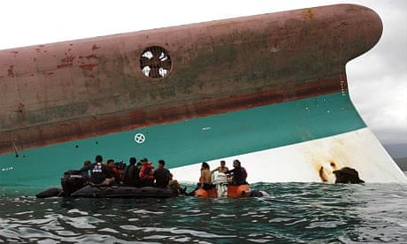 Divers on a rubber boat wait beside the capsized ferry MV Princess of Stars, off Sibuyan island
