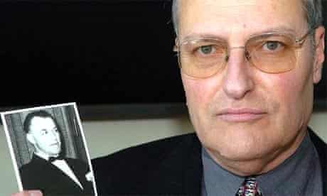 Efraim Zuroff, the head of the Simon Wiesenthal Centre, holds a photograph of his number one target, the Nazi war criminal Aribert Heim