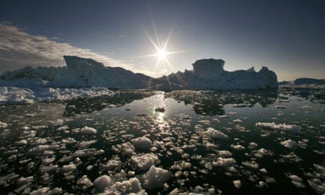 Icebergs are reflected on the water's surface near Jakobshavn fjord, Ilulissat
