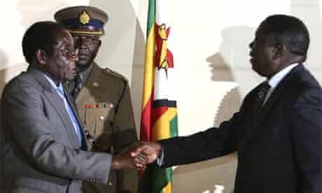 The Zimbabwe president, Robert Mugabe, left, shakes the hand of Morgan Tsvangirai, the Movement for Democratic Change leader, at the signing of a memorandum of understanding between the two parties in Harare