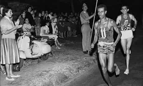 Abebe Bikila of Ethiopia, running barefoot, draws away from Abdesselem Rhadi of Morocco near the finish of the marathon at the 1960 Rome Olympics. He went on to win with a new Olympic record time of 2 hours 15 minutes 16 seconds