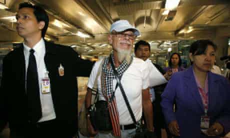 British rocker Gary Glitter walks towards an airline gate at Bangkok's Suvarnabhumi airport where he refused to board a plane back to the UK