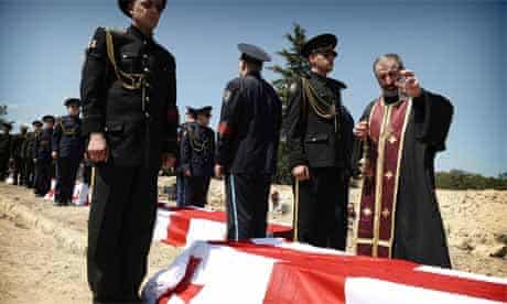 A patriarch blesses coffins of unknown Georgian soldiers in Mukhadgverdi, west of Tbilisi; on August 28, 2008