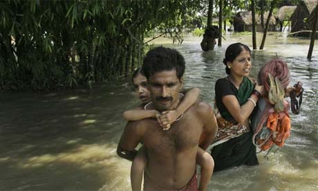 A family wades through flood waters to catch a relief boat, northeast of Patna, India, Aug. 31, 2008
