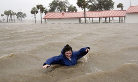 A woman walks through flood waters in New Orleans
