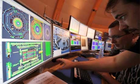 Cern scientists look at computer screens during LHC switch-on
