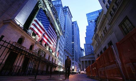A man walks past the New York Stock Exchange