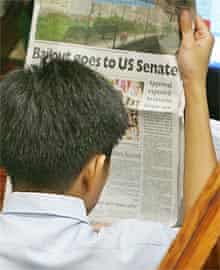 A trader reads the paper at the Philippines Stock Exchange