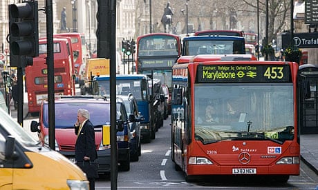 A bus stands in heavy traffic in Trafalgar Square, London