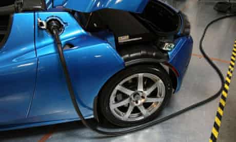 A power cable is plugged into a Tesla Roadster after a news conference with California governor Arnold Schwarzenegger at Tesla Motors in San Carlos, California