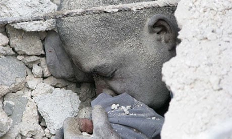 The head of a male student, still alive, trapped under the Haiti school rubble