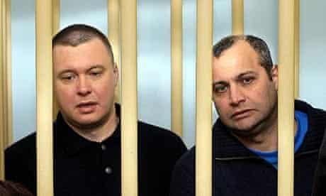 Former FSB (previously KGB) agent Pavel Ryaguzov (L) and Sergei Khadzhikurbanov, suspects in the murder case of Russian journalist Anna Politkovskaya, sit in the defendents' cage in a Moscow court