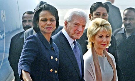 Condoleezza Rice waves as she walks alongside the US ambassador to India, David C Mulford, following her arrival in Delhi