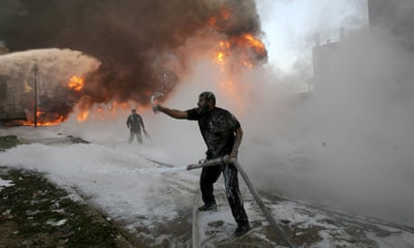 A man fights a fire at a medicine storehouse in the Gaza Strip town of Rafah.