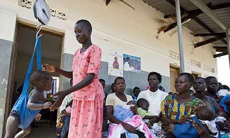 Babies and toddlers are weighed during an immunisation programme at the Ojom health centre, Katine