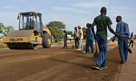 Workers under the supervision of Chinese contractors resurface the Lira road, Katine