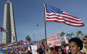 A woman holds an American flag during a May Day parade at the Revolution square in Havana, Cuba EPA