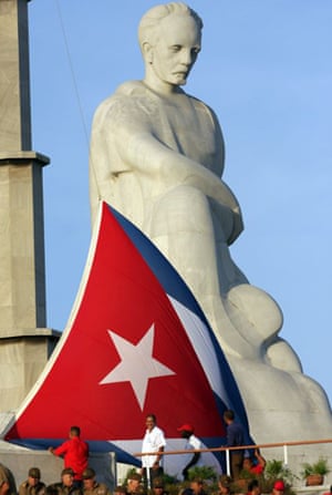 A Cuban flag is seen near a statue of José Martí during the annual May Day parade in Havana  