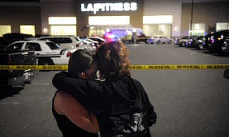 Two women embrace at the scene of a shooting at a fitness centre in Bridgeville, Pennsylvania