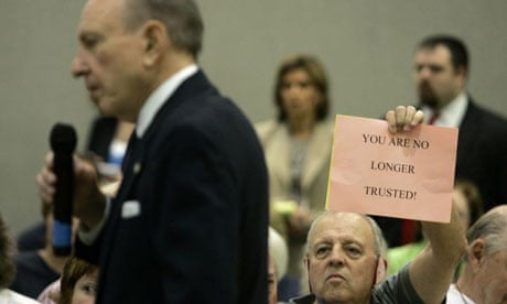 Tom Davis holds a sign as US senator Arlen Specter speaks during a town hall meeting in Lebanon, Pennsylvania.
