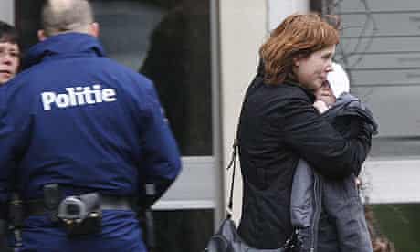 A woman and her child leave the creche in Dendermonde, scene of a knife attack