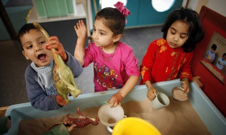 Children play with sand at Abbey Green Nursery School and Childrens' Centre in Bradford