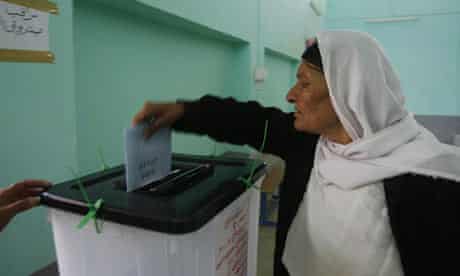 A woman casts her vote at a polling station in Sinjar