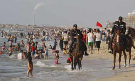 Mounted Hamas officer rides along beach at Gaza City