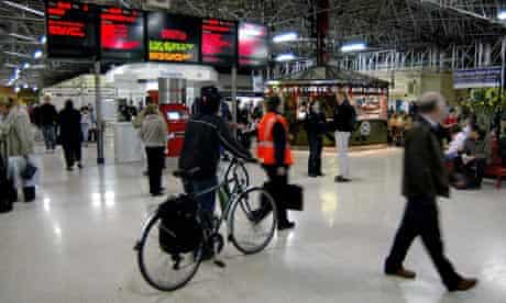 Bike blog: bikes and trains: Cyclist pushing his bicycle at Marylebone railway station in London