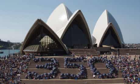 Climate change activists form the number 350 at the Sydney Opera House in Australia