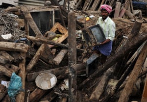 Flooding in India: A flood victim recovers his television set