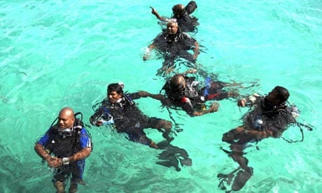 Maldivian cabinet members dive in training for an underwater cabinet meeting